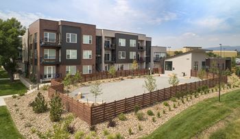 An aerial view of an apartment complex with a large patio and landscaping